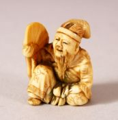 A JAPANESE MEIJI PERIOD CARVED IVORY NETSUKE - SEATED MAN - carved depicting a seated scholar or