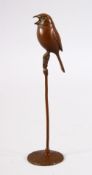 A JAPANESE BRONZE MODEL BIRD ON STAND - the underside with a seal mark 16cm