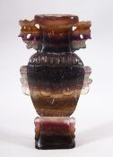 A CHINESE CARVED AMETHYST STONE VASE - Carved in the form of a vase and decorated with flora, 20cm