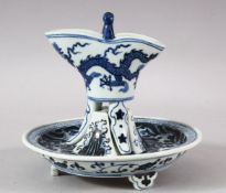A CHINESE MING STYLE BLUE & WHITE PORCELAIN LIBATION CUP & STAND - the cup decorated with dragon,