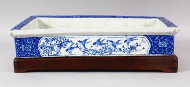 A 19TH CENTURY JAPANESE BLUE & WHITE PORCELAIN PLANTER & HARDWOOD STAND - the planter decorated with