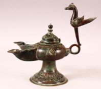 A PATINATED BRONZE OPENWORK INCENSE BURNER, the handle in the form of a bird, with twin spouts, twin