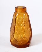 A CHINESE AMBER GLASS & GOLD FLAKE SNUFF BOTTLE, of tapering hexagonal form.
