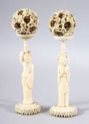 A PAIR OF 19TH CENTURY CHINESE CARVED IVORY FIGURES & PUZZLE BALLS - both figures stood holding