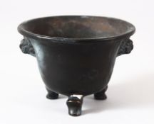 A CHINESE TWIN HANDLE BRONZE INCENSE BURNER / CENSER, with tripod feet and twin lion dog mask