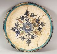 A RARE 16TH CENTURY INDIAN MULTAN POTTERY DISH, the centre painted with a floral spray within a