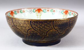 A CHINESE FAMILLE ROSE PORCELAIN BOWL, the exterior with blue ground and gilt decoration, 28cm