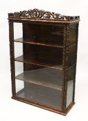 A 19TH CENTURY CHINESE CARVED HARDWOOD AND GLASS DISPLAY CABINET, profusely carved with fruit and