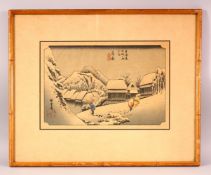 A JAPANESE WOODBLOCK PRINT of a snowy landscape, depicting figures, signed and sealed, 52cm x 42cm.