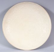 A CHINESE SONG STYLE DING YAO PORCELAIN PLATE - the interior with dragons and clouds - the underside