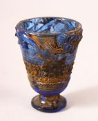 A CHINESE ARCHAIC STYLE BLUE GLASS CUP, decorated with chilong, 7cm high.