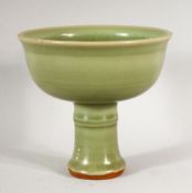 A GOOD CHINESE CELADON STEM CUP, the inside with incised decoration, 14cm diameter, 13cm high.