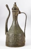 A ISLAMIC / TURKISH BRASS EMBOSSED EWER / COFFEE POT - carved with flora, 41cm high