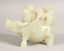 A CARVED WHITE JADE FIGURE riding a buffalo, 9cm long.