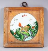 A CHINESE FAMILLE VERTE FRAMED PORCELAIN PANEL - the plaque depicting a kylin amongst foliage -
