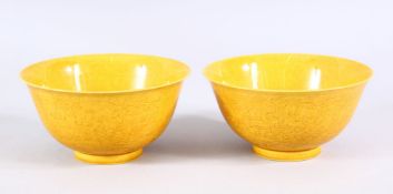 A PAIR OF CHINESE YELLOW GROUND DRAGON TEA BOWLS - each with incised decoration interior, dragon