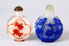 TWO CHINESE OVERLAY GLASS SNUFF BOTTLES - one of frosted glass with a blue overlay depicting