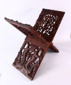 A LARGE CHINESE SIAMESE CARVED WOODEN BOOK STAND, carved with openwork of mythical beast and