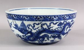 A CHINESE MING STYLE BLUE & WHITE PORCELAIN DRAGON BOWL - the bowl decorated with twin dragons
