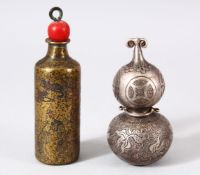 TWO CHINESE METAL SNUFF BOTTLES - one white metal and engraved with goldfish and symbols, the base