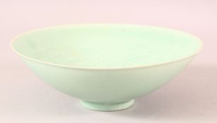 A CHINESE CELADON GLAZED POTTERY BOWL, the interior with sgraffito incised decoration, 20.5cm
