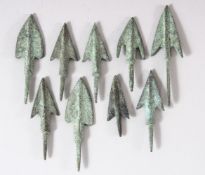 NINE SMALL METAL ARROW HEADS, various sizes; largest 7.5cm.