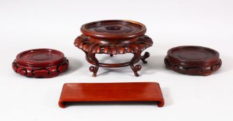 FOUR CHINESE CARVED WOODEN STANDS - 8cm - 8.9cm - 11cm ( circular stands) together with a