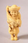 A LARGER JAPANESE MEIJI PERIOD CARVED IVORY NETSUKE - MAN AND PEACOCK - the man stood holding in his