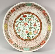 A VERY GOOD CHINESE FAMILLE ROSE CIRCULAR DISH, the centre with chrysanthemums and other flowers,