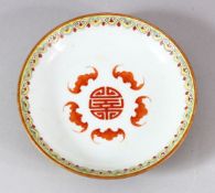 A CHINESE PORCELAIN SAUCER DISH, the dish painted with bats surrounding the longevity symbol, the