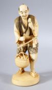 A JAPANESE MEIJI PERIOD CARVED IVORY OKIMONO - - the man stood holding his basket full of produce,