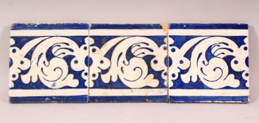 THREE ISLAMIC BLUE AND WHITE TILES, each approx. 13cm square.