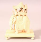 AN EARLY 20TH CENTURY CARVED IVORY GROUP, of an elephant with mahoot, a houda on its back containing