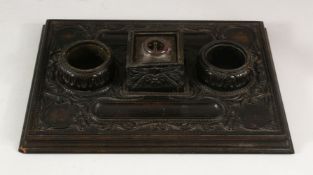 A 19TH CENTURY SRI LANKAN OR CEYLONESE CARVED EBONY DOUBLE SIDE DESK STAND, with cut glass central