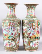 A PAIR OF CHINESE CANTON PORCELAIN VASES, painted with panels of predominantly female figures,