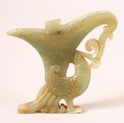 A CHINESE CARVED GREEN JADE PENDANT of a libation cup and bird, 10cm x 10.5cm.