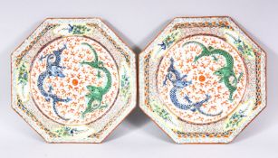 A PAIR OF CHINESE FAMILLE ROSE OCTAGONAL PORCELAIN PLATES - each decorated with twin dragons