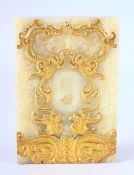 A CHINESE CARVED GILT JADE TABLET - decorated with twin dragon and phoenix, 12cm x 8cm
