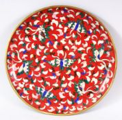 A 19TH CENTURY CHINESE CLOISONNE SAUCER DISH - decorated with a red ground and butterflies - 22cm