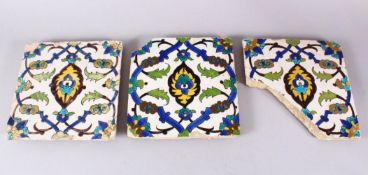 A SET OF THREE EARLY SAFAVID POTTERY TILES, each with the same decoration, white ground ith blue