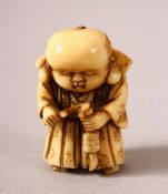 A JAPANESE MEIJI PERIOD CARVED IVORY NETSUKE OF A BOY - the boy stood holding and looking down at