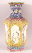 A CHINESE FAMILLE ROSE / FAMILLE JAUNE HEXAGONAL PORCELAIN VASE, painted with six oval panels
