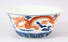 A CHINESE BLUE AND IRON RED PORCELAIN DRAGON BOWL, painted with two dragons chasing the flaming