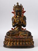 A TIBETAN GILT COPPER FIGURE OF YOGIMI / BUDDHA - in a seated pose with its hand crossed - poly