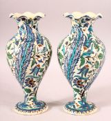 A PAIR OF TURKISH OTTOMAN KUTAHIYA POTTERY VASES, painted with decorative floral sprays, 26.5cm