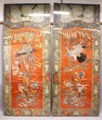 AN IMPRESSIVE PAIR OF CHINESE EMBROIDERED SILK PANELS, each central coral red ground panel