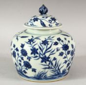 A CHINESE BLUE AND WHITE PORCELAIN JAR AND COVER, the body decorated with floral sprays, overall