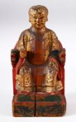 A CHINESE CARVED WOOD & LACQUER FIGURE OF A SEATED BOY - the boy sat upon23cm a chair leaning,