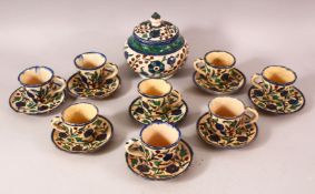 A SET OF EIGHT PALETINIAN JERUSALEM POTTERY COFFEE CUPS AND SAUCERS, together with a sugar bowl,