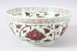 A CHINESE PORCELAIN IRON RED FLOWER BOWL, the interior and exterior painted with numerous flowers,